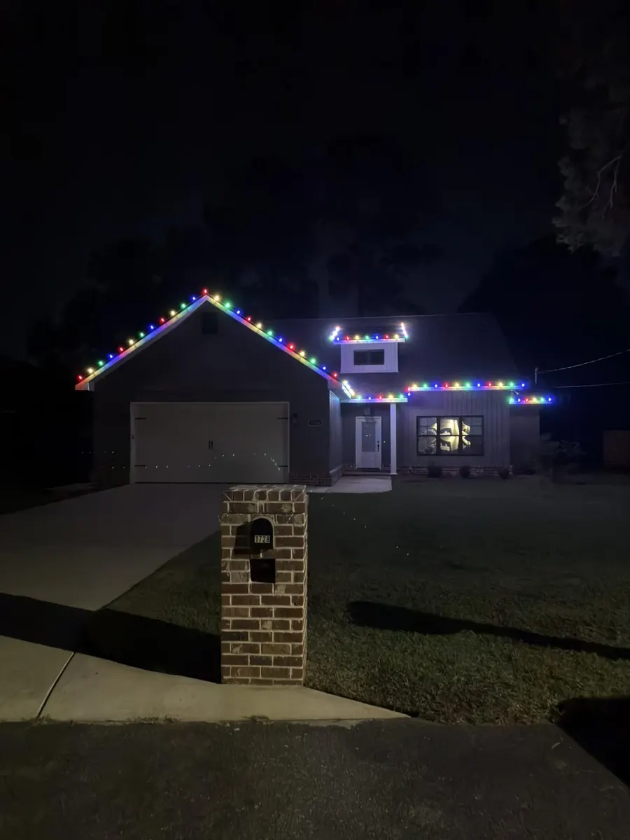 Home with multicolor Christmas lights along rooflines