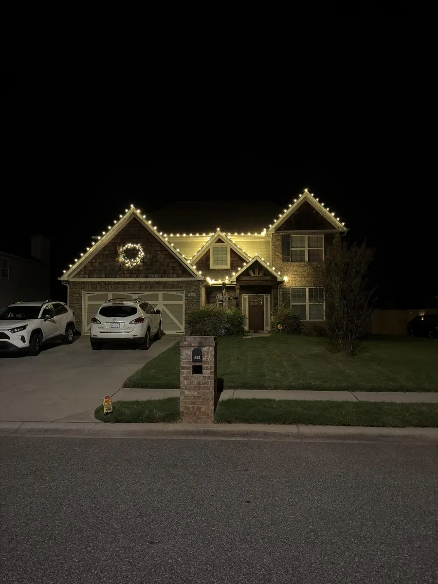 Two-story home with warm white roofline lights