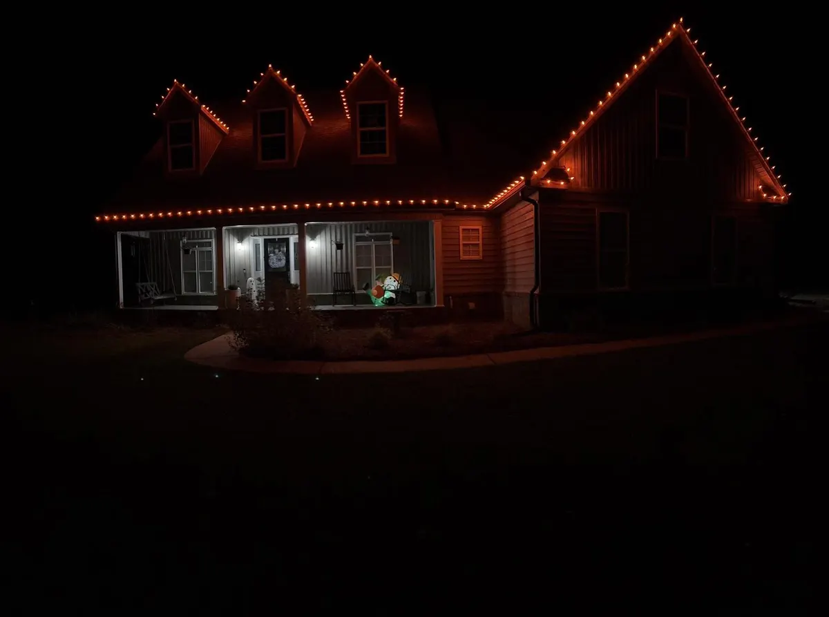 Country home with orange seasonal lighting